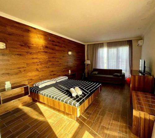 a bedroom with a bed and a couch in it at Del Mar in Ureki