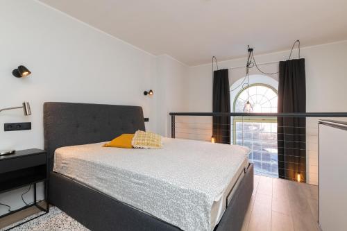 a bedroom with a bed and a large window at Hilltop Apartments - Ilmarine district in Tallinn