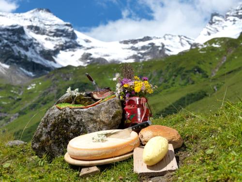 a table with bread and flowers on top of a mountain at Apartment am See in Zell am See