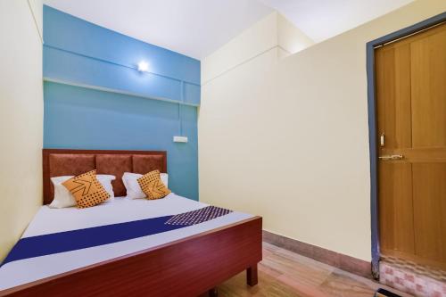 a bedroom with a bed with a blue wall at SPOT ON Luv-kush Inn in Bankipur