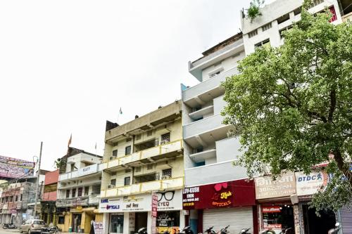 a tall white building on a city street at SPOT ON Luv-kush Inn in Bankipur