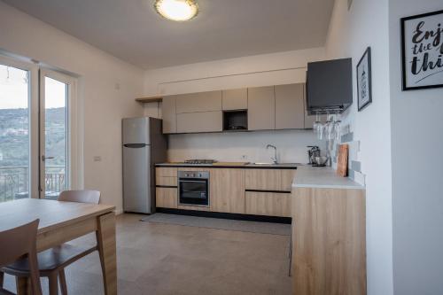 a kitchen with a refrigerator and a table with a table sidx sidx at Miravesuvio in Pimonte