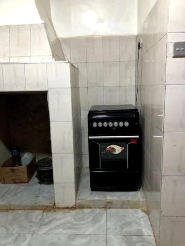 a kitchen with a black stove in a room at Aberdare Home in Othaya