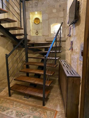 a staircase in a building with a clock on the wall at Ürgüp Inn Cave Hotel in Urgup