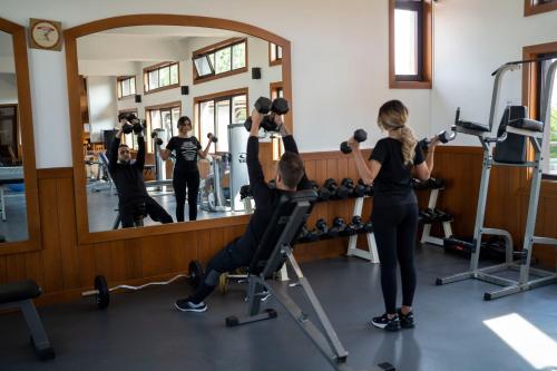 a man and a woman in a gym mirror at Boutique Complex Trakiets in Zhitnitsa