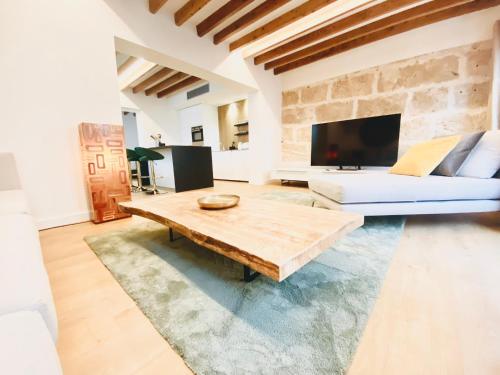 a living room with a couch and a coffee table at Hotel-Apartment with big terrace in Palma de Mallorca