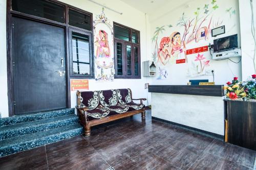 a waiting room with a bench in front of a door at OYO Hotel Blue Lotus in Pushkar