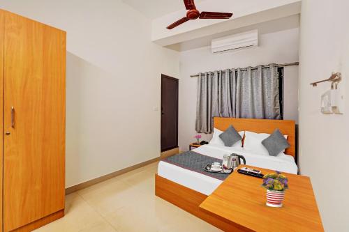 a hotel room with a bed and a table at Townhouse 999 INN24 Airport in Chennai