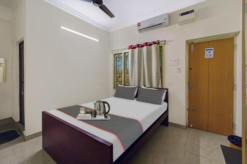 a bedroom with a bed with a trophy on it at Collection O Arn Guest House Near Chennai International Airport in Chennai