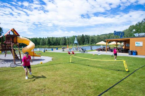 a park with a playground with people playing at Amenity Hotel & Resort Lipno in Lipno nad Vltavou