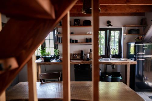a kitchen with a table and a refrigerator at Libling Hruštička in Banská Štiavnica