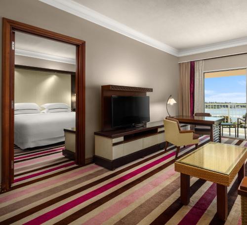 a hotel room with a bed and a television at RIHGA Royal Laguna Guam Resort in Tamuning