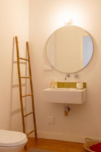 a bathroom with a sink and a mirror at Casa do Almirante in Tavira