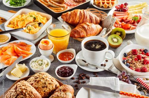 a table filled with different types of breakfast foods at Aangan Resort Ranthambhore - A Private Pool Villa in Khilchipur