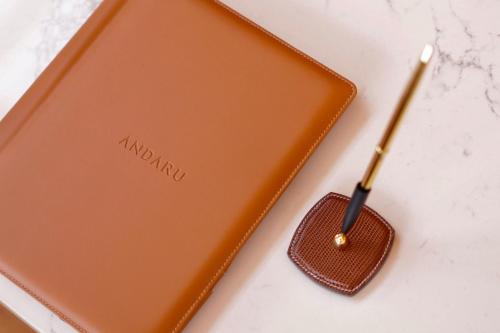 an orange smartphone next to a usb stick at Andaru Collection Niseko in Kutchan