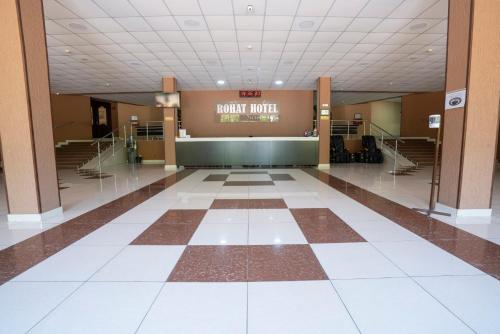 a lobby of a building with a checkerboard floor at Rohat Hotel Chilonzor in Tashkent