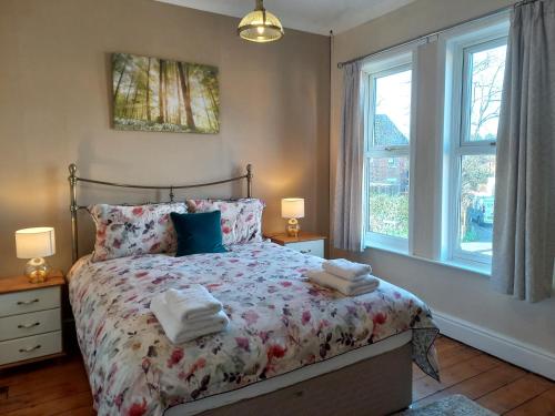 a bedroom with a bed with towels on it at Charming 4-Bed Victorian House in Retford in Retford