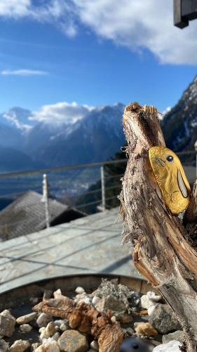 a statue of a bird sitting on a pile of rocks at Chalet Sonnenröschen in Blatten bei Naters