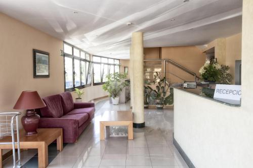 a living room with a couch and a table at Hotel Tereñes Costa in Ribadesella