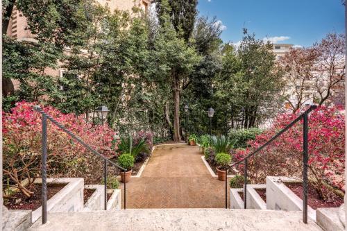 a set of stairs with pink flowers and trees at Mangili Garden Hotel in Rome