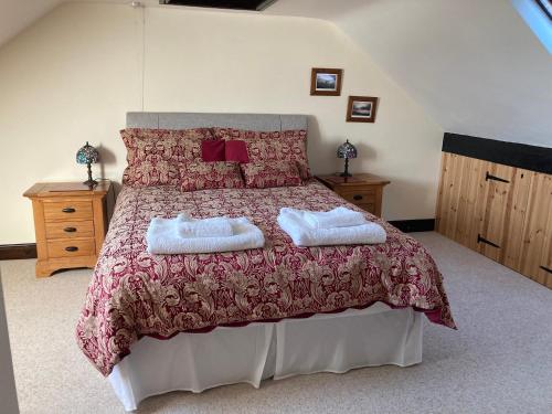 a bedroom with a bed with two towels on it at The Smithy in Richmond