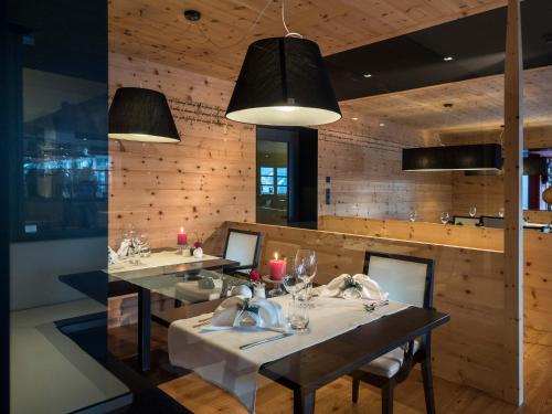 a dining room with two tables and two sinks at Farmhotel Moosmair in Campo Tures