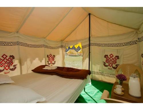 a bedroom with a bed in a tent at Dorje Camps Sarchu, Manali in Manāli