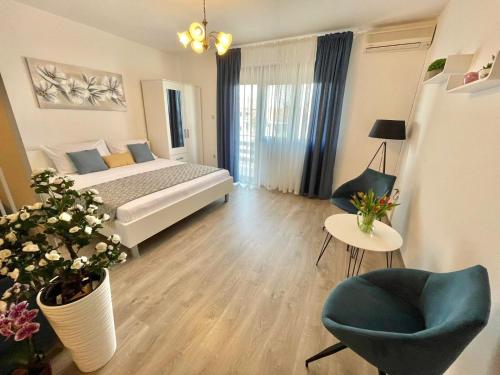 a bedroom with a bed and a chair and a table at Apartmani Selina in Jadranovo