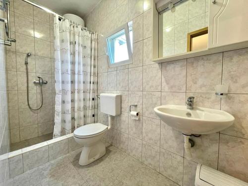 a bathroom with a toilet and a sink at Apartmani Selina in Jadranovo
