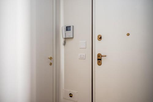 a white door with a lock on it at Officina7 Large in Parma