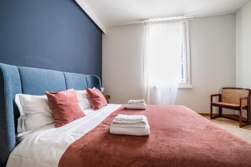 a bedroom with a large bed with two towels on it at Officina7 Large in Parma