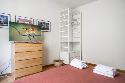 a bedroom with a bed and a tv on a dresser at Officina7 Large in Parma