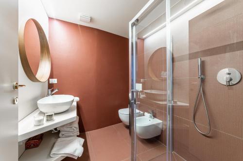 a bathroom with a shower and a toilet and a sink at Officina7 Large in Parma
