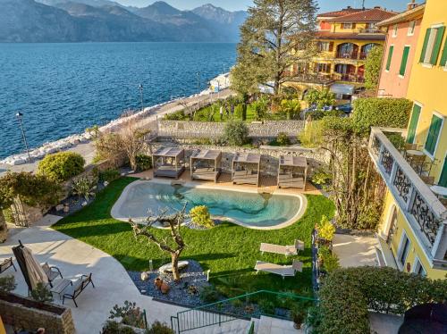 an aerial view of a resort with a swimming pool and the ocean at Lake Front Hotel Brenzone in Brenzone sul Garda