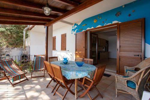 a dining room with a table and chairs on a patio at casa sulla spiaggia 2 in Orosei