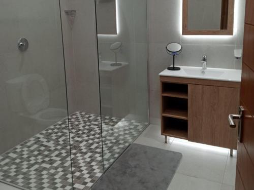 La salle de bains est pourvue d'une douche et d'un lavabo. dans l'établissement Drakenzicht Mountain Cottage, à Winterton