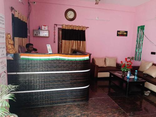 a man sitting in a room with a bar at Super OYO Kirti Inn in Puri