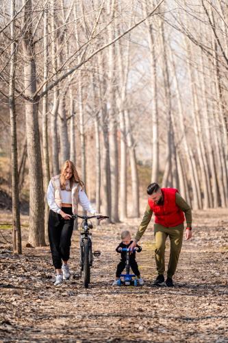 a family walking a bike in the woods at Boutique Complex Trakiets in Zhitnitsa