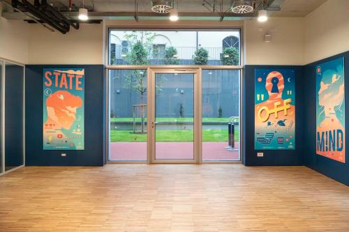 a room with doors and posters on the walls at aparto Milan Giovenale in Milan
