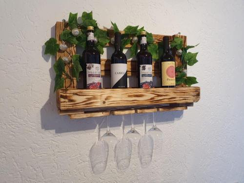 a bunch of wine bottles hanging on a wall at Ferienwohnung Hertreiter in Dingolfing 110qm in Dingolfing