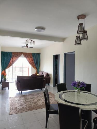 a living room with a table and a couch at Alyaleesya Emerald avenue 4 Brinchang for muslim in Brinchang