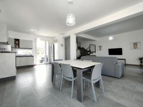 a kitchen and living room with a table and chairs at Villa Milicia in Altavilla Milicia
