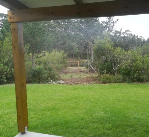 a view of a yard from a porch at Beessential Farm in The Crags