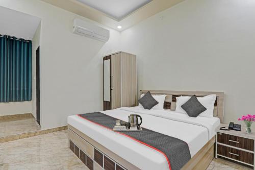 a bedroom with a large white bed and a window at Townhouse 1160 P.s.Palace Near Amausi Metro Station in Lucknow