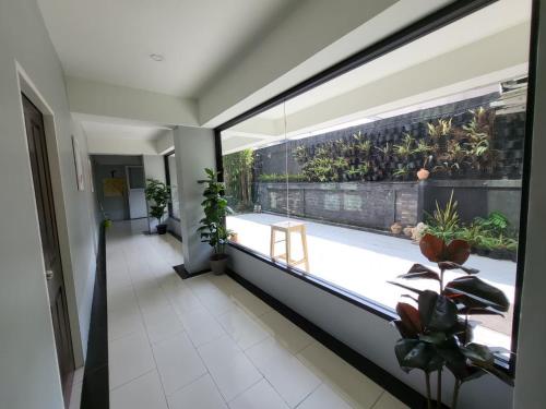 a room with a large window with a view of a patio at RoomQuest Bangkok Don Mueang Airport in Bangkok