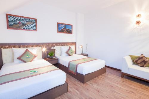 Postel nebo postele na pokoji v ubytování Ben Tre Riverside Resort
