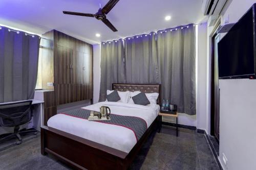 a bedroom with a large bed and a flat screen tv at OYO Townhouse 1090 G SILVER HOTELS NEAR US BIOMETRIC in Chennai