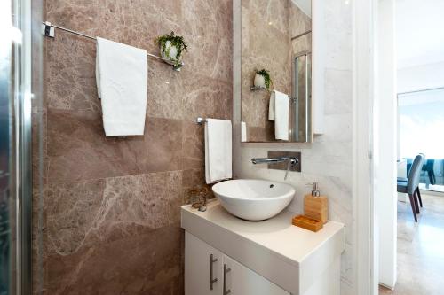 a bathroom with a sink and a mirror at Apartment Marisol - Beachfront in Protaras