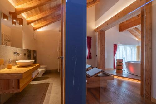 a bathroom with a tub and a sink and a toilet at Casera Degnona in Chies dʼAlpago