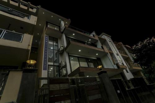 a large building at night with a fence at OYO Townhouse 1071 Hotel Metro Inn Residency Near ISKCON Temple Noida in Indirapuram
